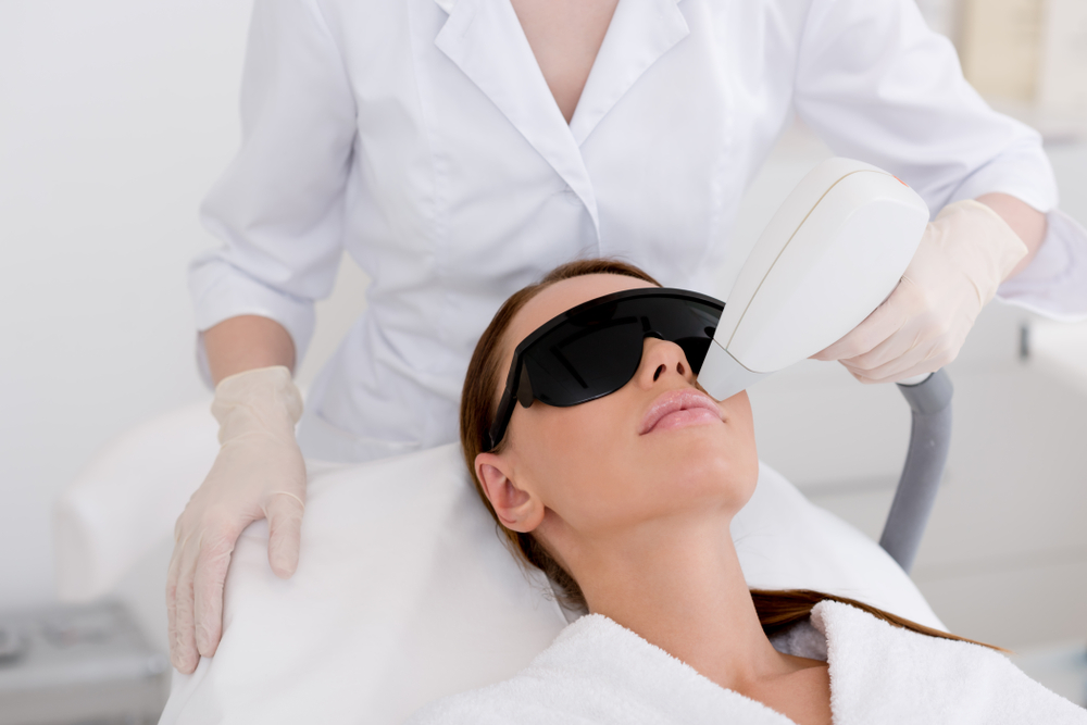 woman receiving laser hair removal treatment to her upper lip