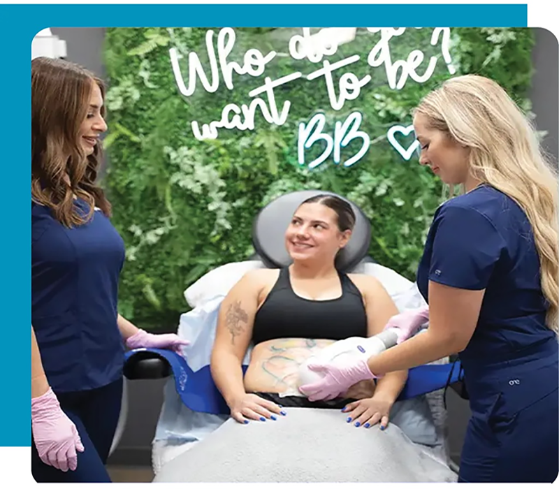 Body contouring treatment session with clinicians using handheld device on patient abdomen in a medical spa setting